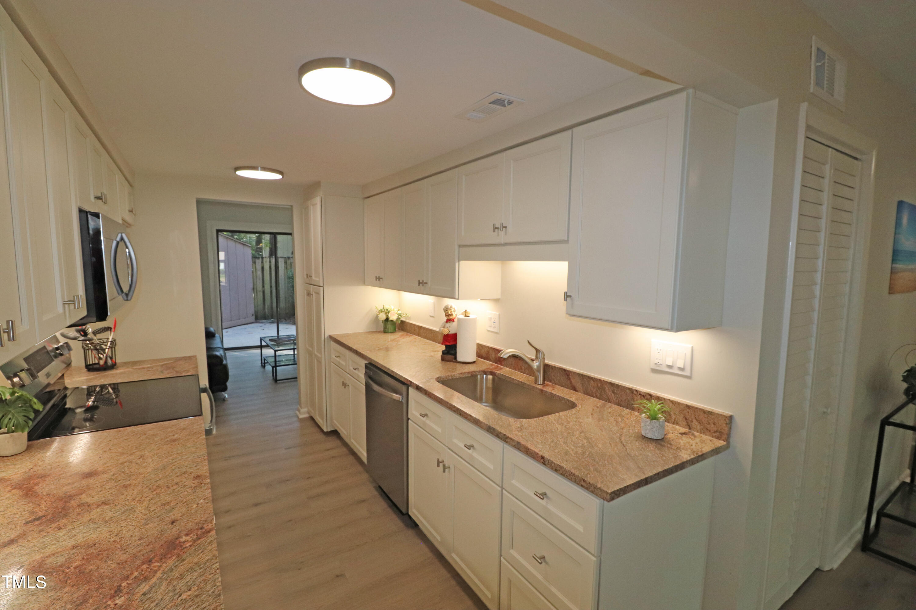 1716 Quail Ridge Road Raleigh, NC 27609 - Photo 10 of 39 a kitchen with granite countertop a sink stove and cabinets