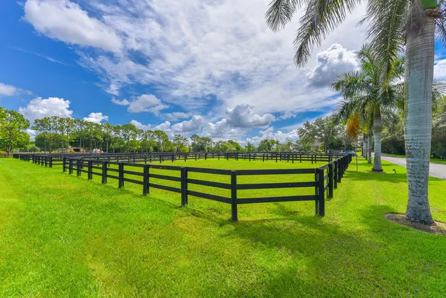 a view of a house with swimming pool and a yard