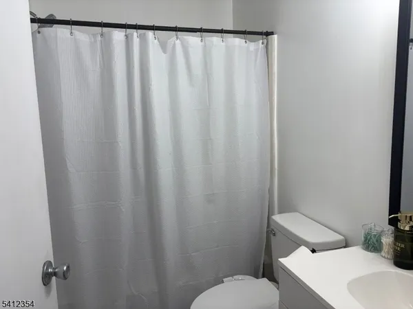 a white toilet sitting next to a small bathroom