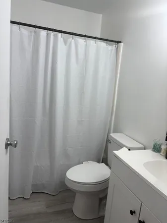 a white toilet sitting next to a white sink