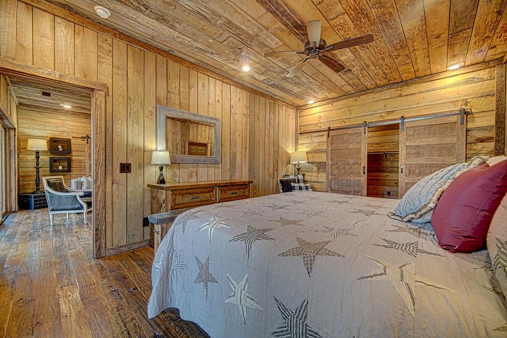 111 Price Circle Blue Ridge, GA 30513 - Photo 13 of 66 a spacious bedroom with a bed and a chandelier