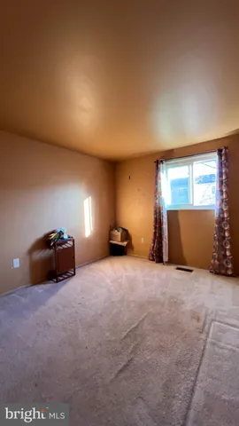 a bed room with a bed and a window