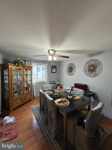 a dining room with furniture and a window