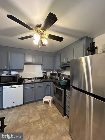 a kitchen with stainless steel appliances granite countertop a refrigerator a stove a sink and a refrigerator