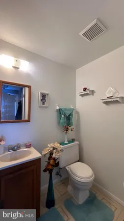 a bathroom with a sink mirror vanity and toilet