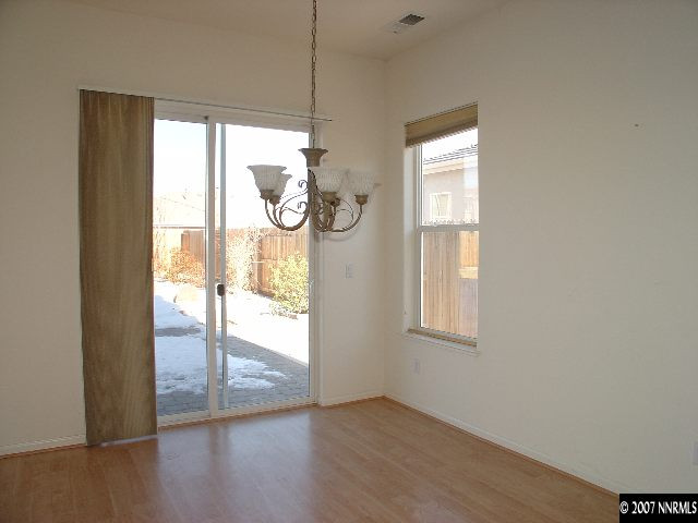 1637 Moquith Court Reno, NV 89521 - Photo 3 of 7 a view of an empty room with wooden floor and a window