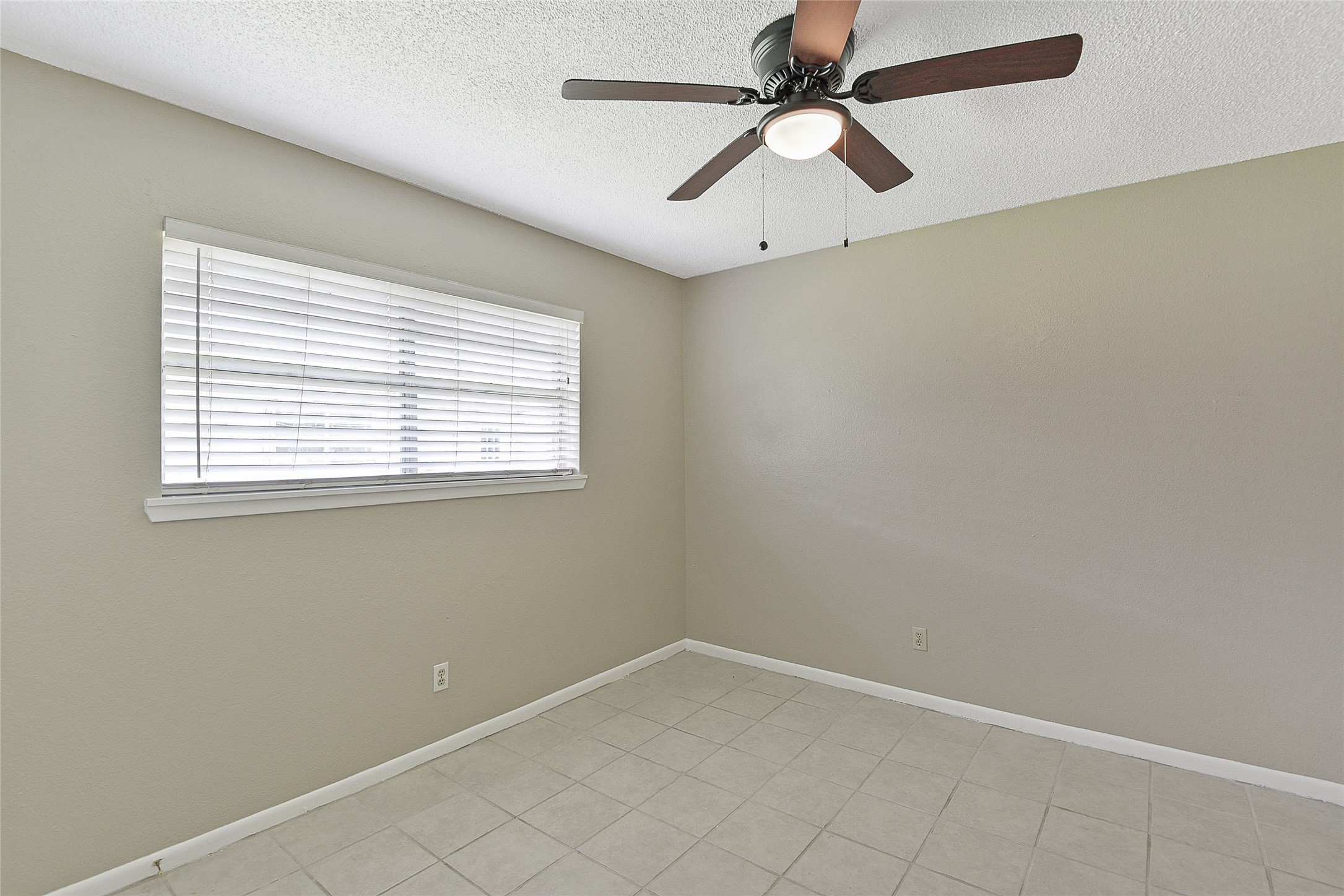 4512 Avenue L, Unit 3 Santa Fe, TX 77510 - Photo 12 of 17 an empty room with a window and a fan