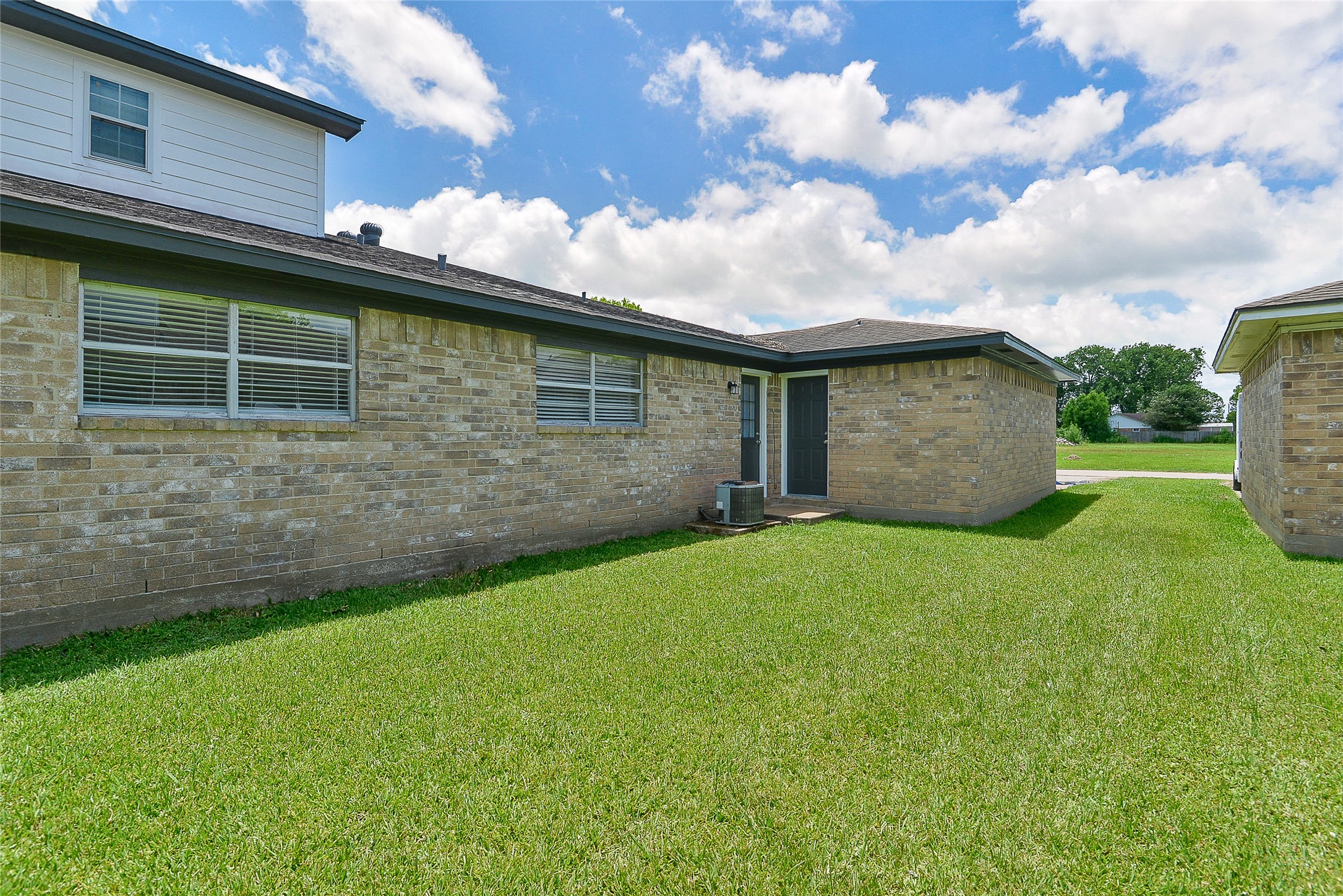 4512 Avenue L, Unit 3 Santa Fe, TX 77510 - Photo 17 of 17 a backyard of a house with lots of green space