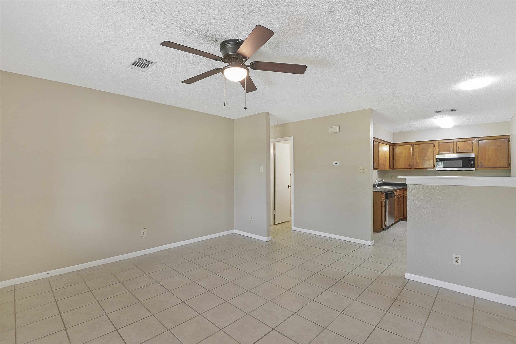 4512 Avenue L, Unit 3 Santa Fe, TX 77510 - Photo 6 of 17 a view of a kitchen with a sink and cabinets