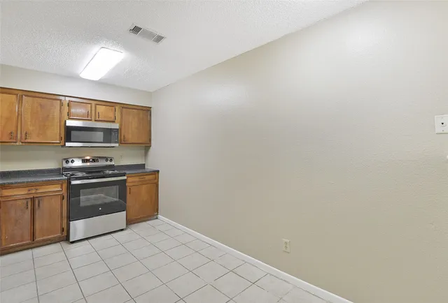 a kitchen with stainless steel appliances a sink and cabinets