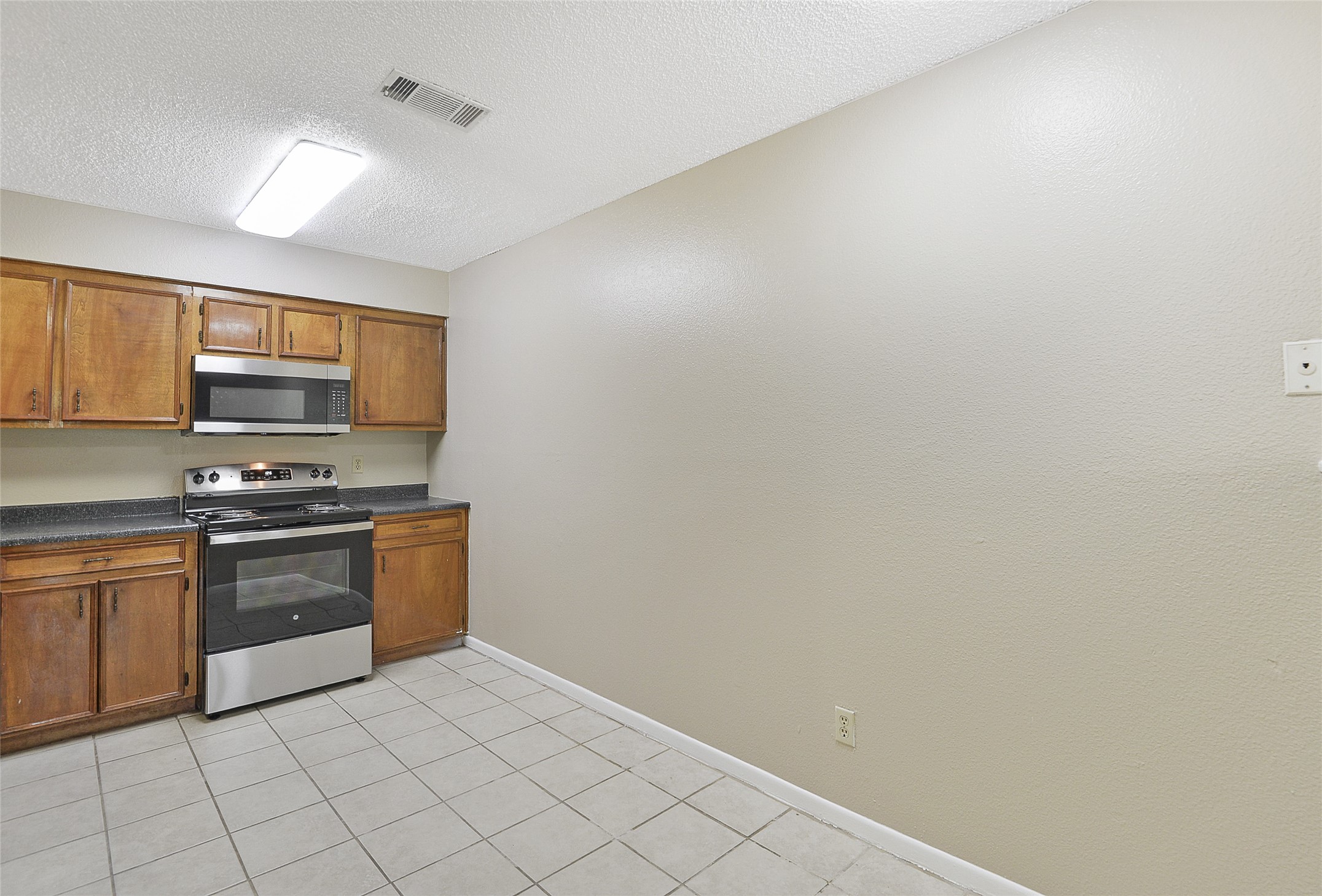 4512 Avenue L, Unit 3 Santa Fe, TX 77510 - Photo 7 of 17 a kitchen with stainless steel appliances a sink and cabinets