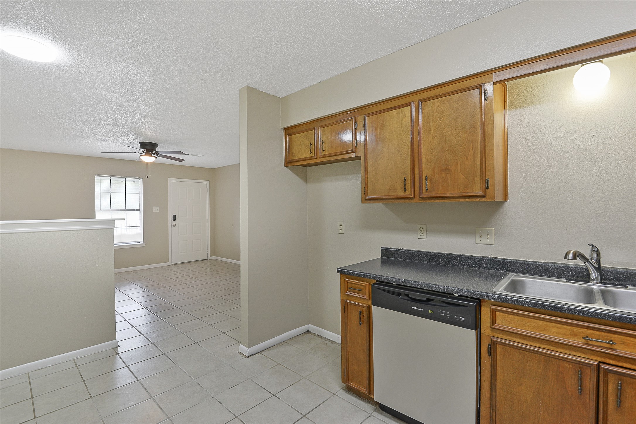4512 Avenue L, Unit 3 Santa Fe, TX 77510 - Photo 9 of 17 a kitchen with stainless steel appliances granite countertop a sink and a refrigerator
