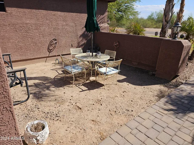a view of a backyard with table and chairs