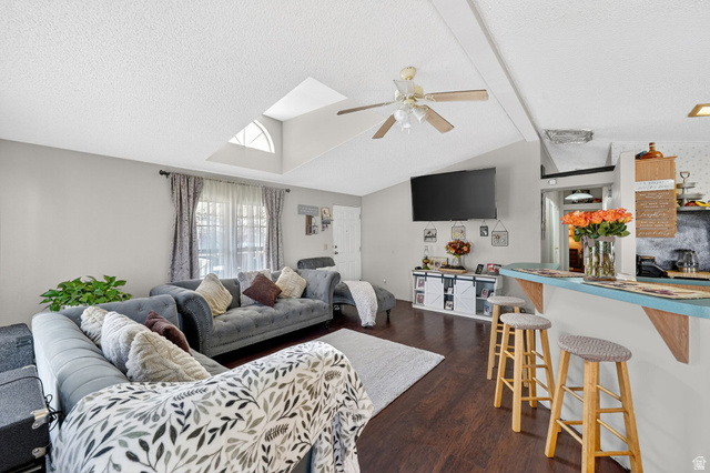 269 Mindella Way, Unit A Layton, UT 84041 - Photo 6 of 37 Living room with beam ceiling, dark wood-style floors, ceiling fan, bar area, and a skylight