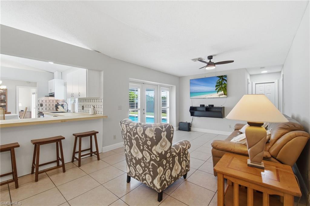 3022 47th Street Southwest Naples, FL 34116 - Photo 20 of 46 Open-concept living space featuring tile flooring and a ceiling fan