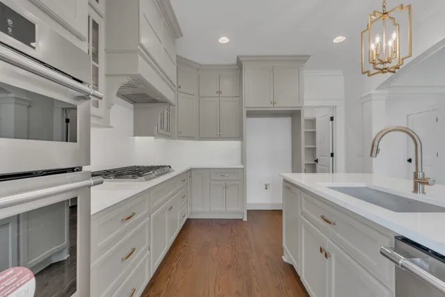 a kitchen with a sink stove and cabinets