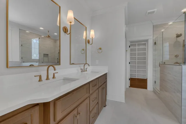 a bathroom with a double vanity sink a and a shower