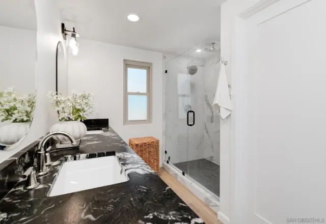 a bathroom with a tub sink and mirror