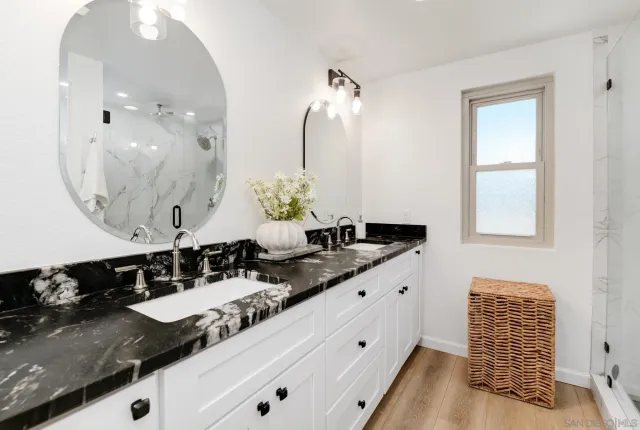 a bathroom with a double vanity sink and a mirror