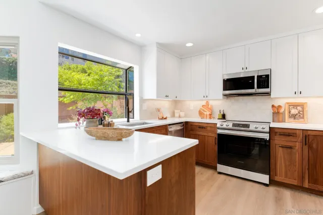 a kitchen with a stove a sink and a microwave