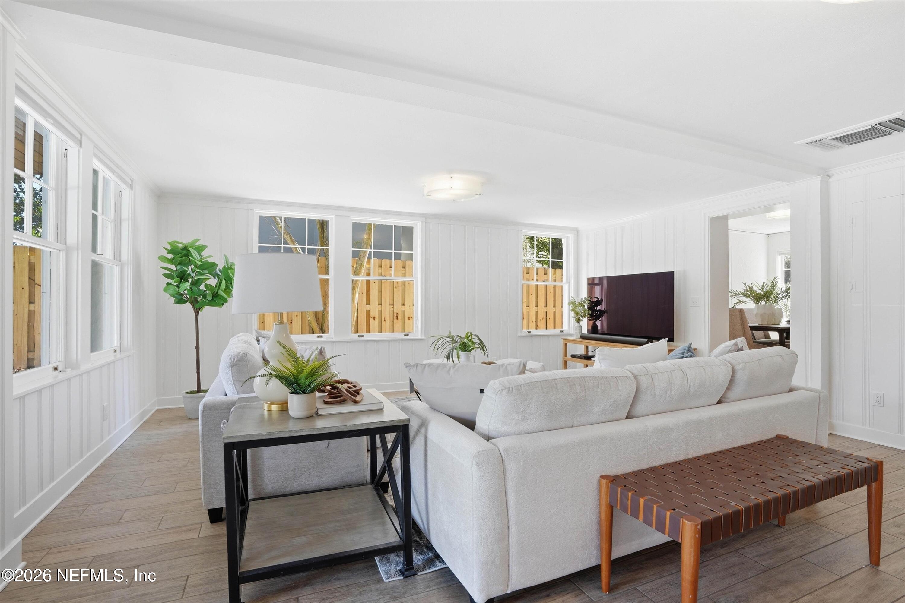 833 Sorrento Road Jacksonville, FL 32207 - Photo 10 of 68 a living room with furniture a flat screen tv and a large window