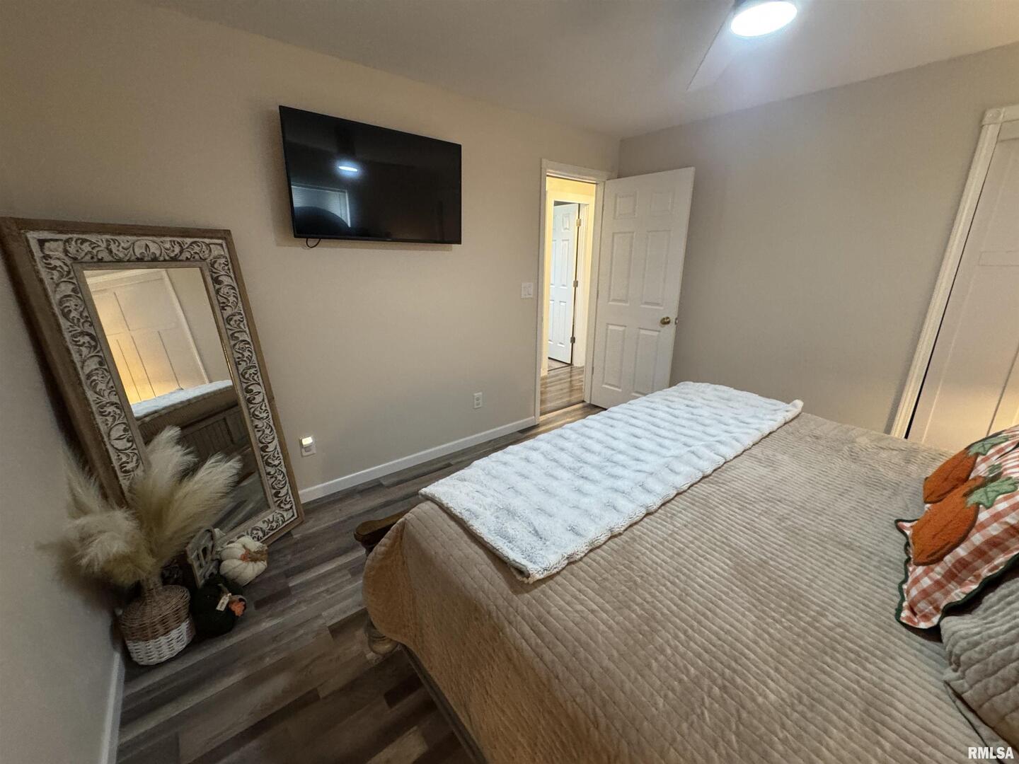 801 West 5th Street Flora, IL 62839 - Photo 17 of 48 a bedroom with a bed and flat screen tv