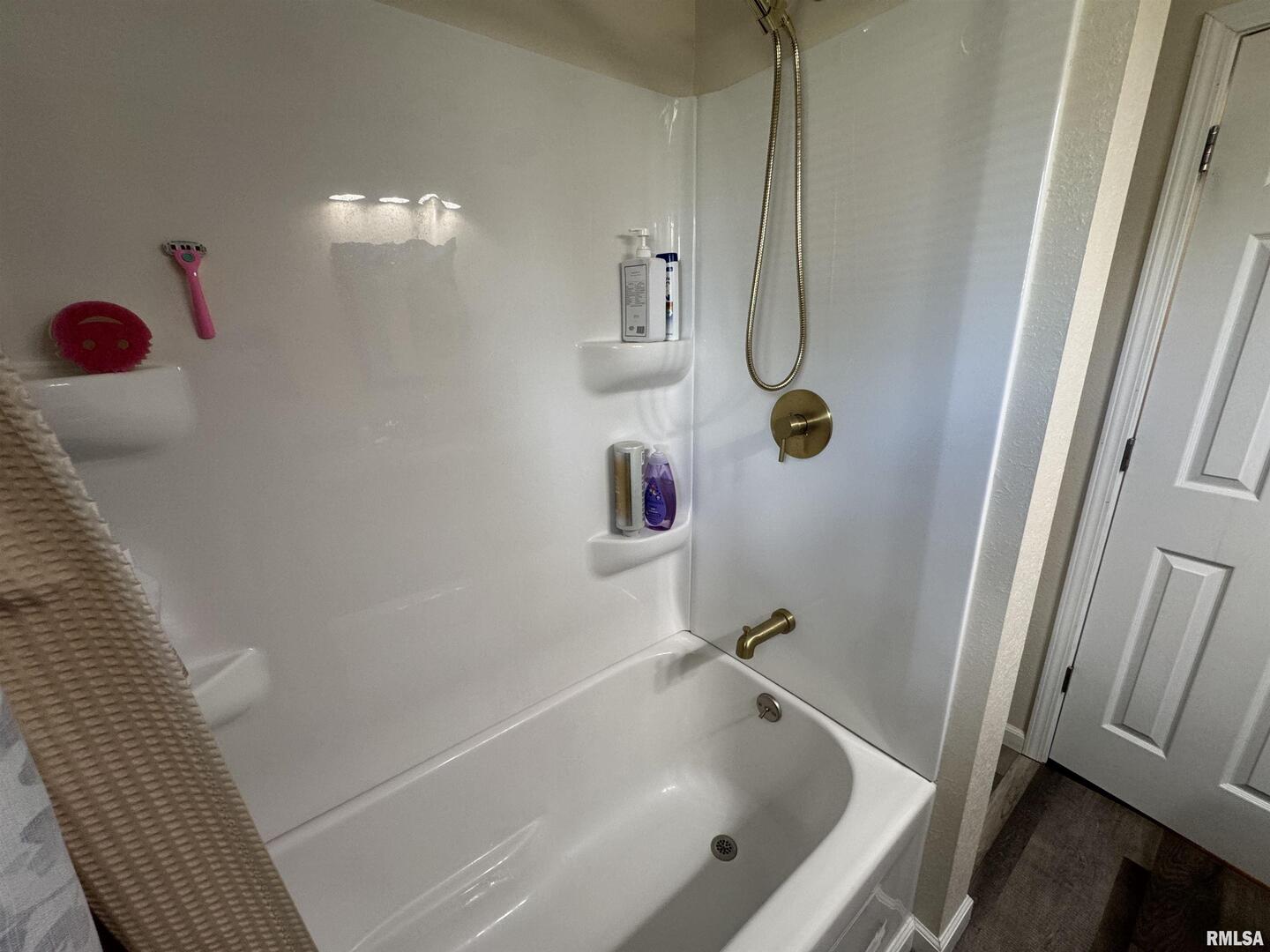 801 West 5th Street Flora, IL 62839 - Photo 25 of 48 a bathroom with a tub and shower