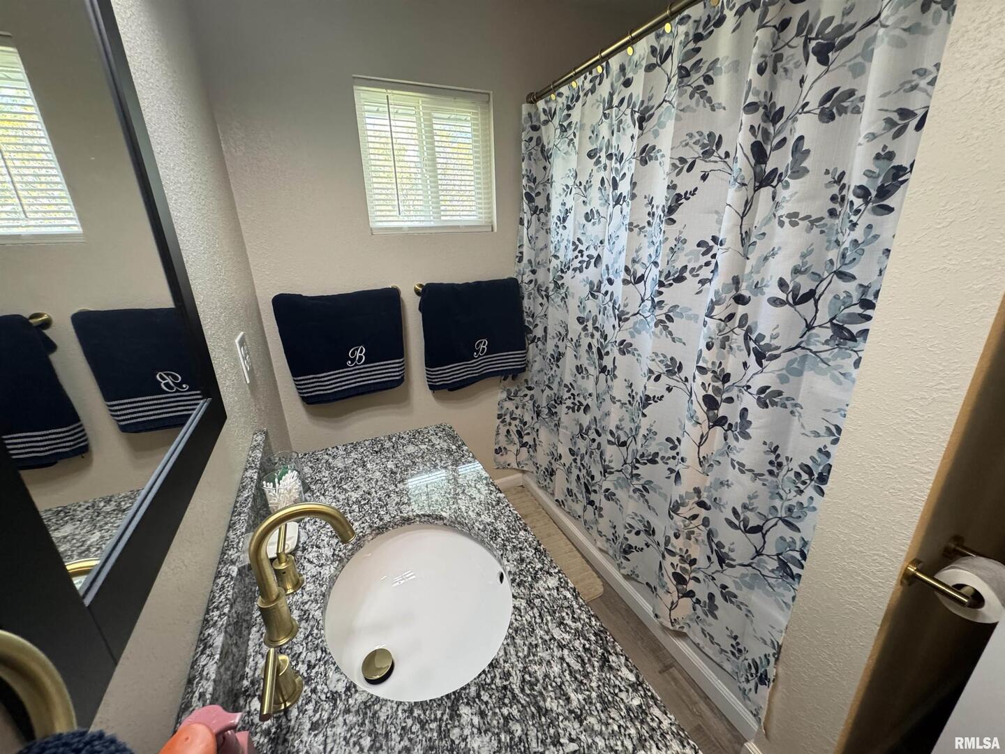 801 West 5th Street Flora, IL 62839 - Photo 27 of 48 a bathroom with a granite countertop sink and a mirror