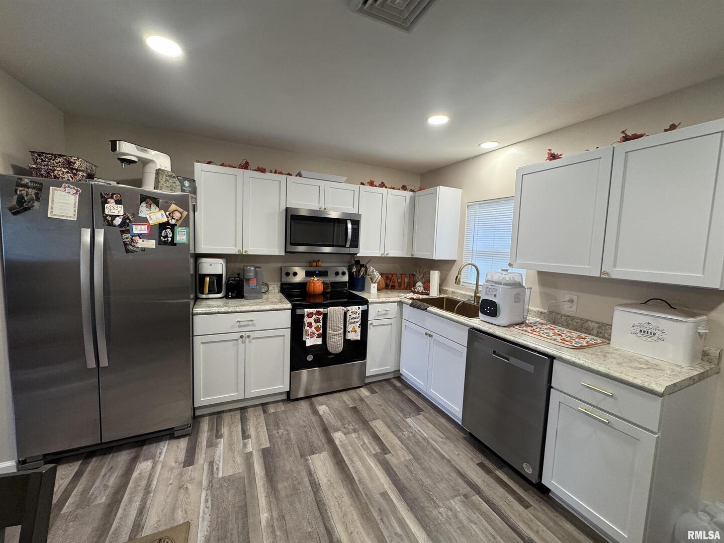 801 West 5th Street Flora, IL 62839 - Photo 34 of 48 a kitchen with a sink stainless steel appliances and white cabinets
