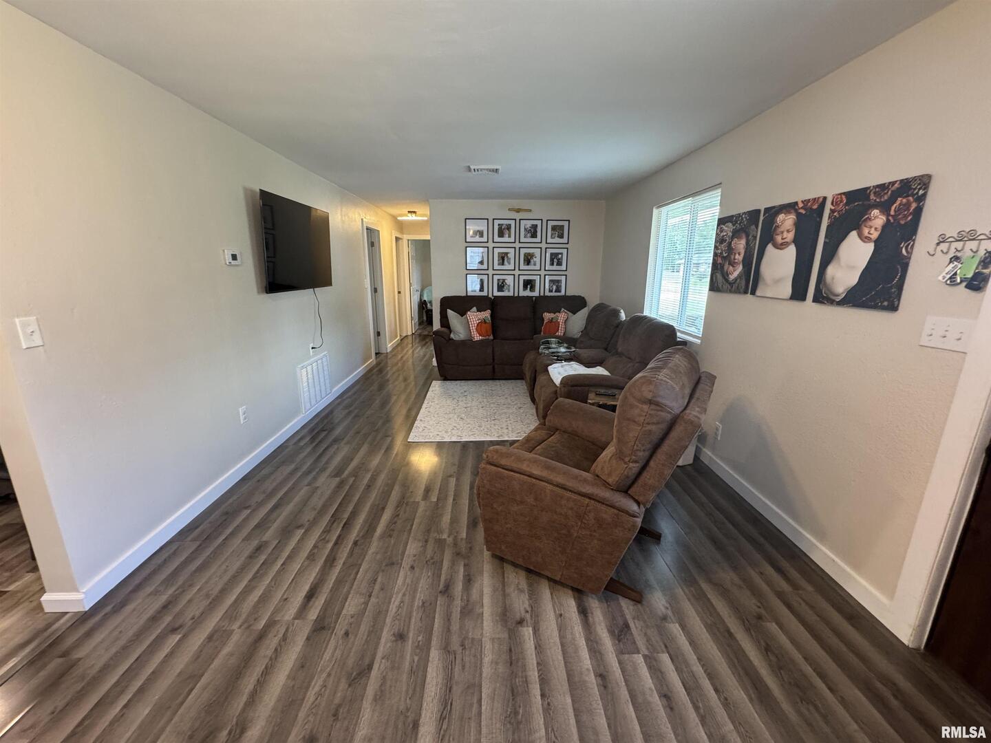 801 West 5th Street Flora, IL 62839 - Photo 6 of 48 a living room with furniture and a flat screen tv