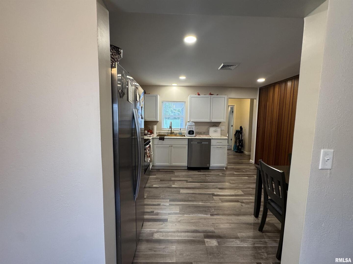 801 West 5th Street Flora, IL 62839 - Photo 7 of 48 a kitchen with refrigerator and cabinets