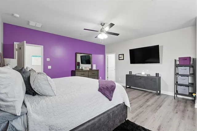 a bedroom with a bed and a flat screen tv