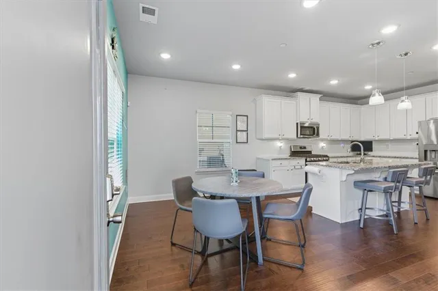 a view of kitchen with cabinets table and chairs