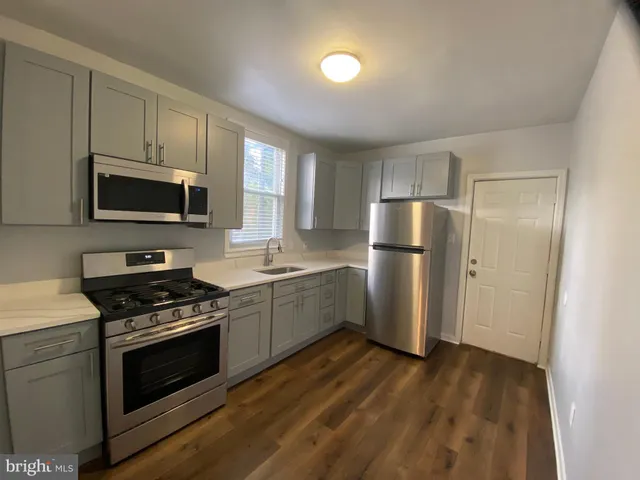 an empty room with closet and windows