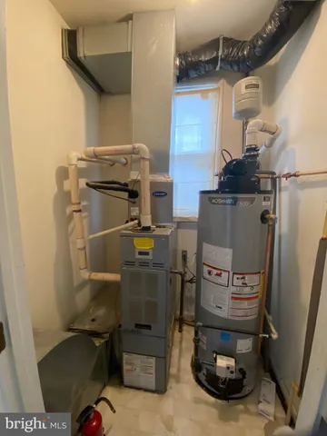 a kitchen with stainless steel appliances a refrigerator a stove and white cabinets