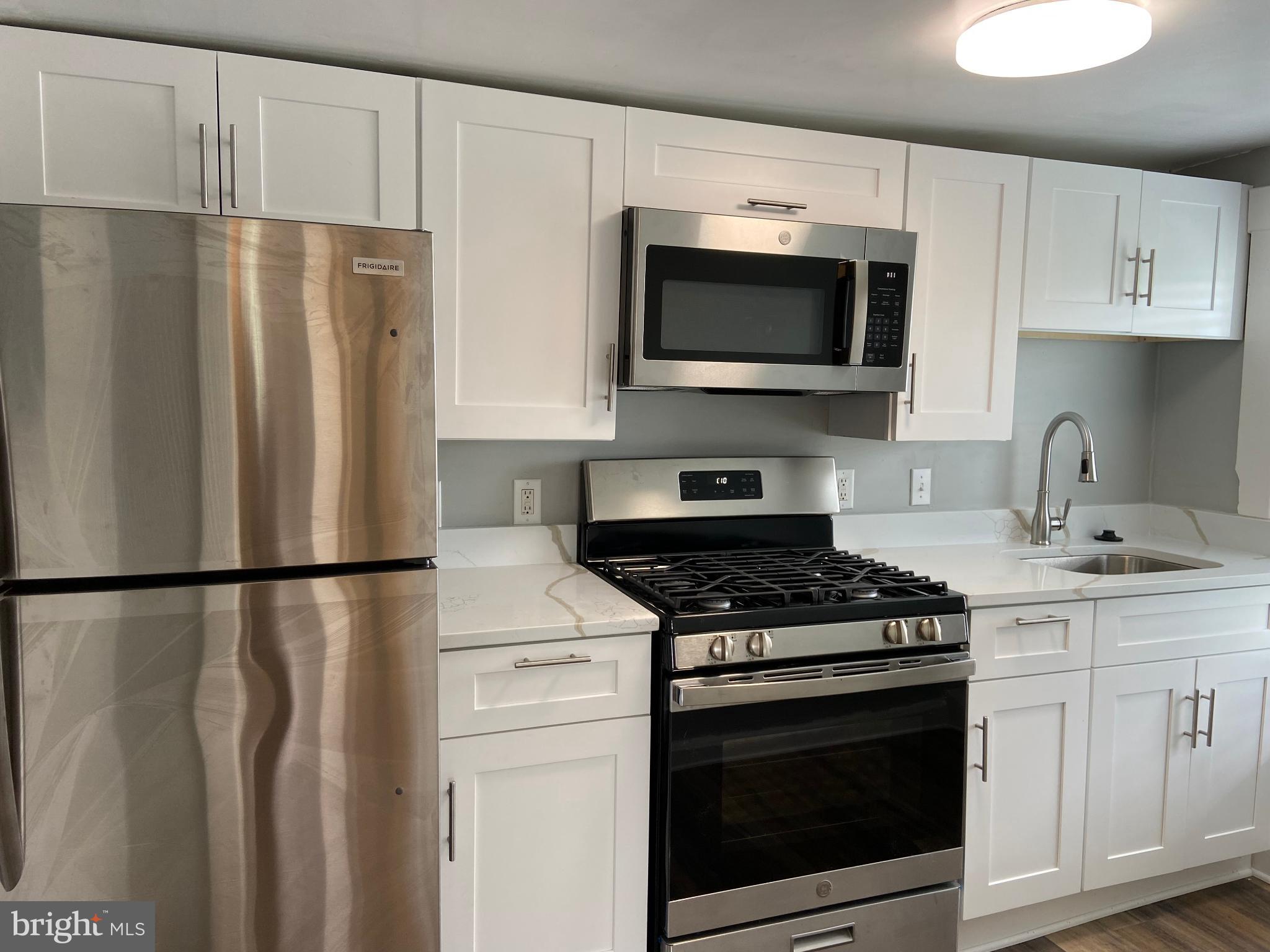 3414 Garrison Boulevard Baltimore, MD 21215 - Photo 37 of 60 Modern kitchen with sleek stainless appliances.