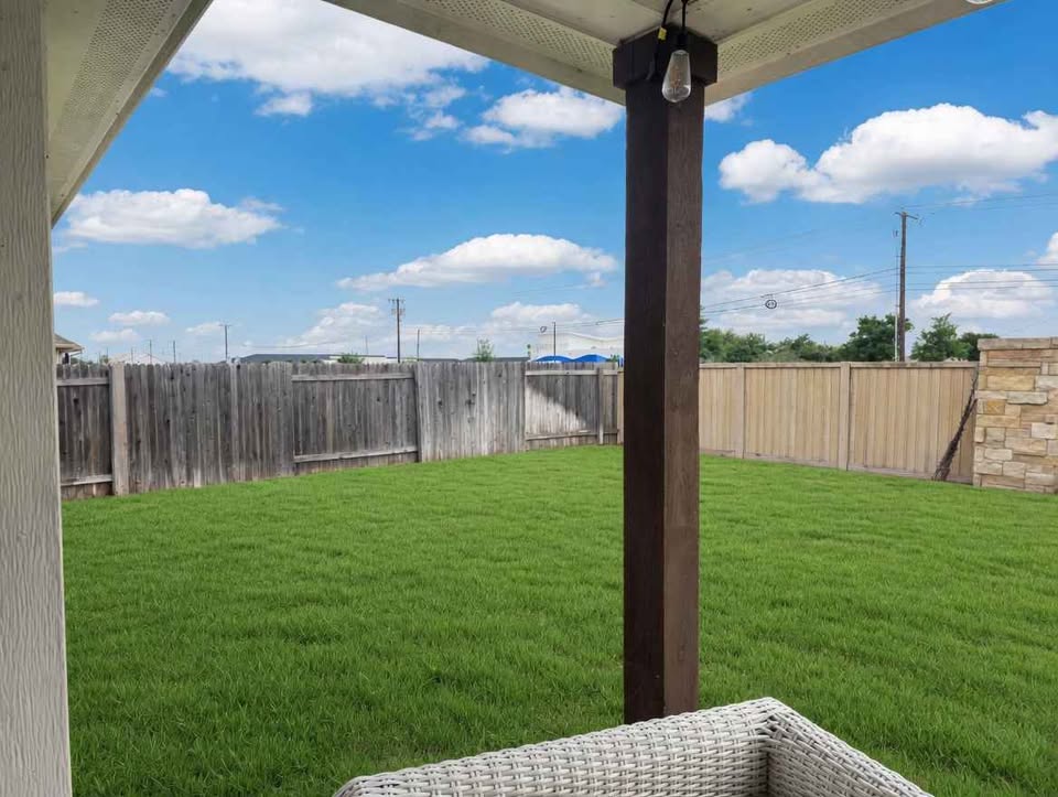 4105 Gildas Path Pflugerville, TX 78660 - Photo 12 of 15 A verdant lawn is enclosed by privacy fencing, creating a serene outdoor haven.