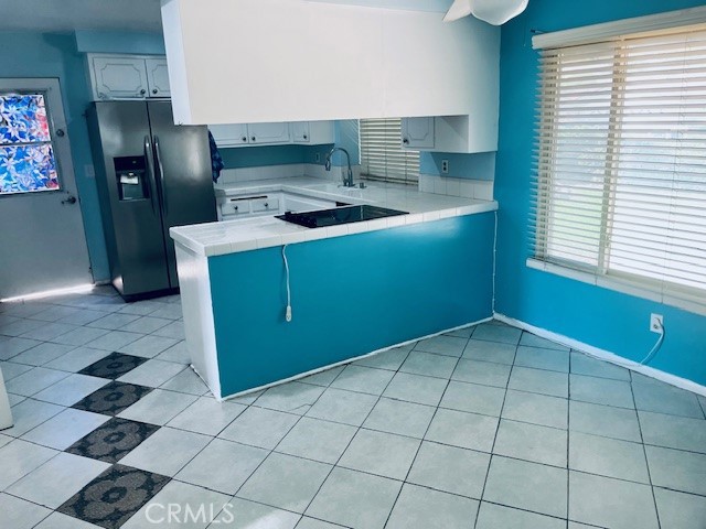 18912 Kinbrace Street Porter Ranch, CA 91326 - Photo 11 of 16 a kitchen with a cabinets a sink a window and stainless steel appliances