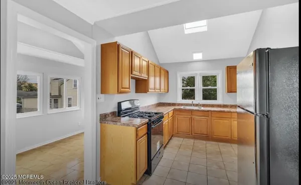 a spacious bathroom with a granite countertop sink and washing machine