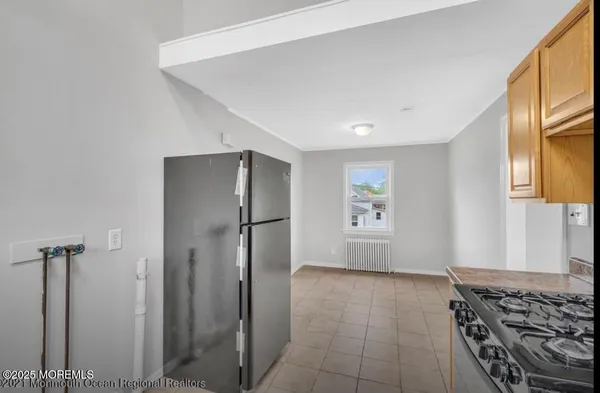 a view of kitchen with stainless steel appliances a refrigerator and a stove top oven