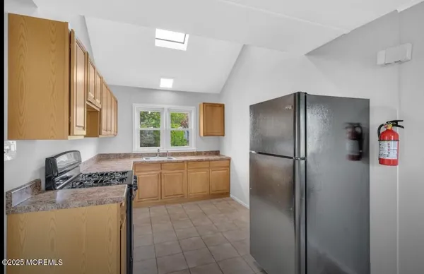 a kitchen with a refrigerator a stove a sink dishwasher and a refrigerator