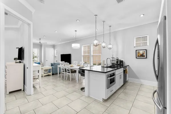 a kitchen with stainless steel appliances a stove a sink and a refrigerator