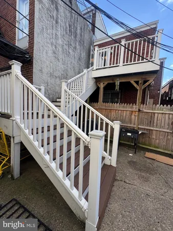 a view of a house with wooden deck