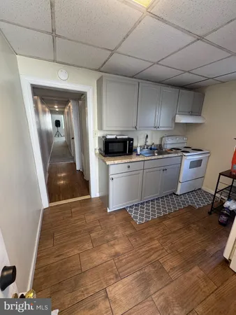 a kitchen with a sink a stove and cabinets