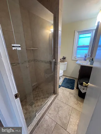 a bathroom with a sink a toilet and a shower