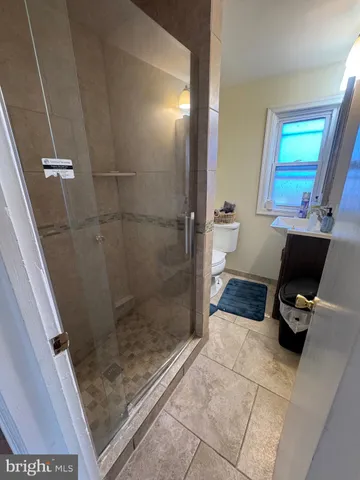 a bathroom with a sink a toilet and a shower