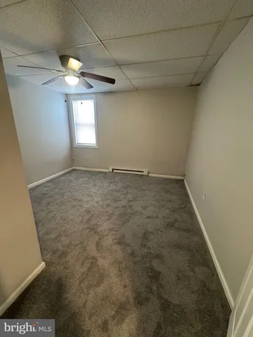 a view of an empty room and a window