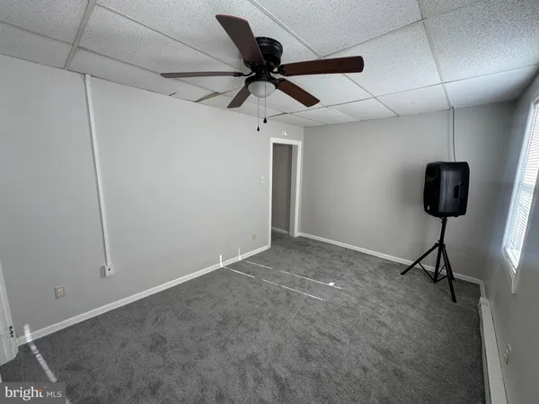 a view of a room with a projector and a ceiling fan