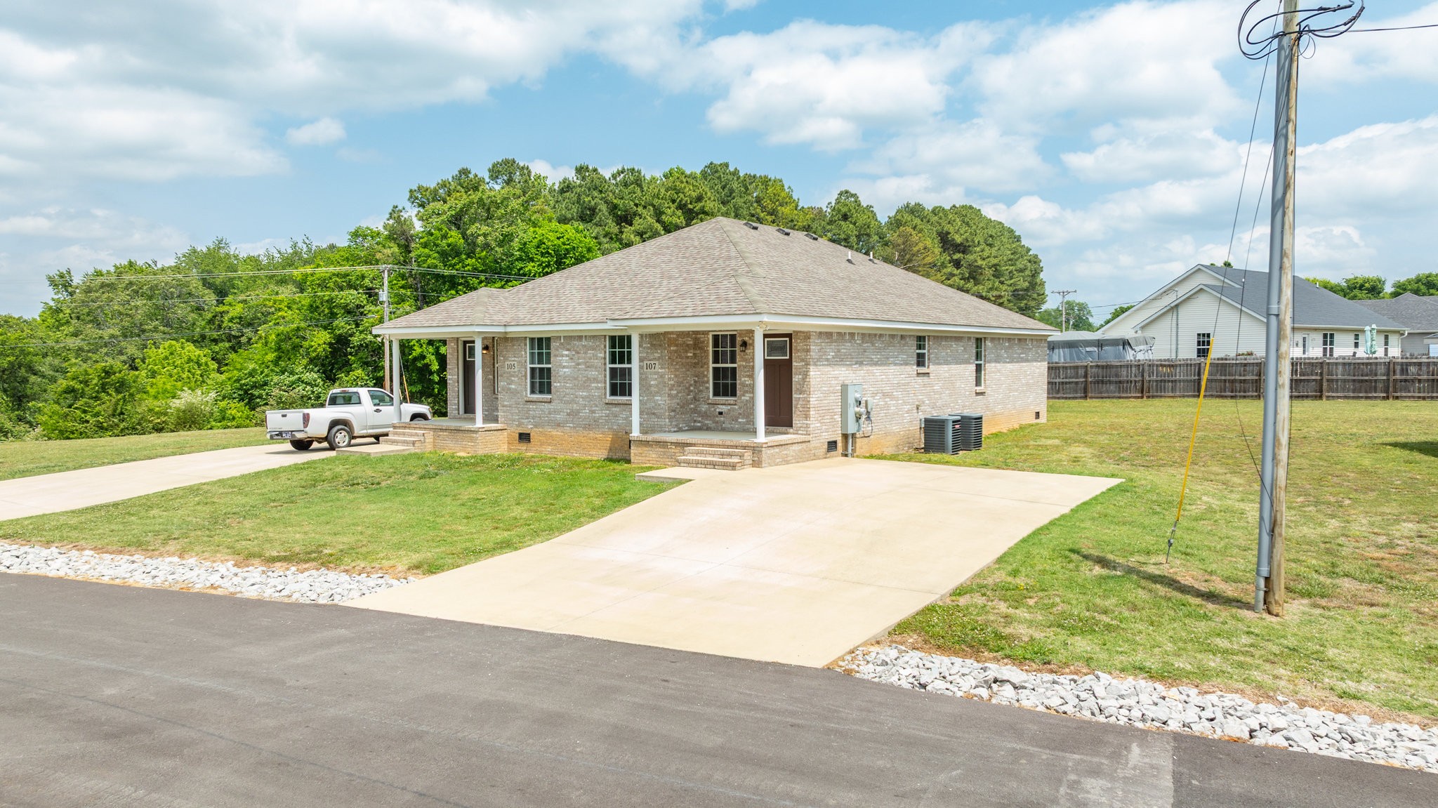 107 Ragsdale Lane Pulaski, TN 38478 - Photo 1 of 25 a view of a house with a yard and table and chairs under an umbrella
