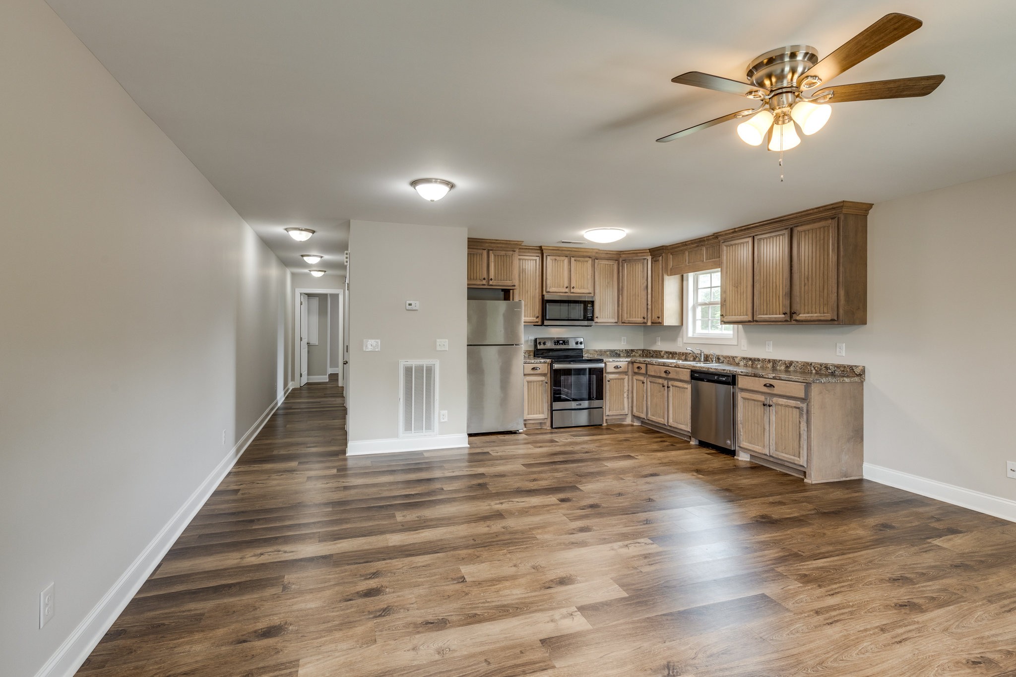 107 Ragsdale Lane Pulaski, TN 38478 - Photo 13 of 25 a kitchen with granite countertop a refrigerator and a stove top oven